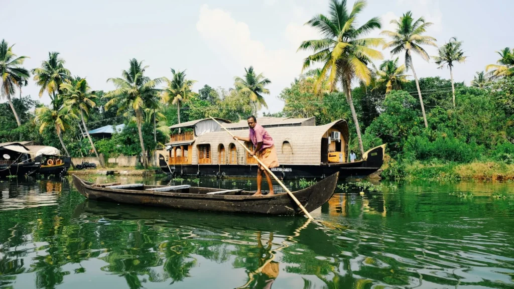 Family relaxing on the deck of a houseboat on the Alleppey backwaters